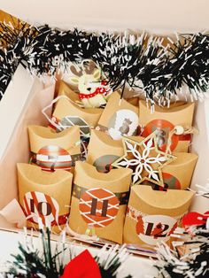 christmas presents are wrapped in brown paper and tied with red ribbon, sitting under a decorated tree