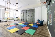 a child's play room with climbing walls and swings