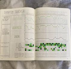 an open book with crosswords and graphs on the pages, sitting on top of a bed