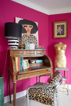 a pink room with a leopard print chair and an old piano in the foreground