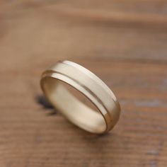 a wedding ring sitting on top of a wooden table