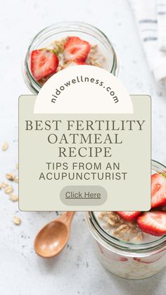 two jars filled with oatmeal and strawberries on top of a table