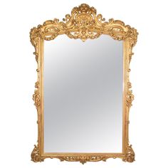 an ornate gold framed mirror against a white background