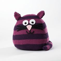 a knitted purple and black cat hat with big eyes on it's head