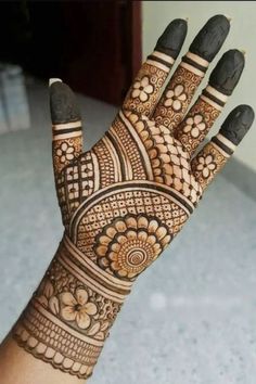 the hand is decorated with intricate designs