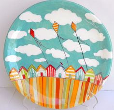 a colorful plate with kites flying in the sky