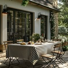 an outdoor dining area with table and chairs