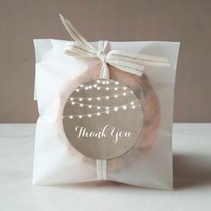 a cookie in a bag with a thank you tag on the front that says,'thank you '