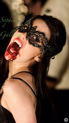 a woman with her mouth open wearing a black mask and fangs on her face for ebay