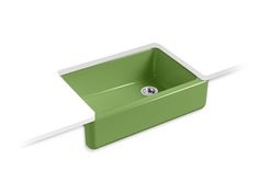 a green sink sitting on top of a white counter