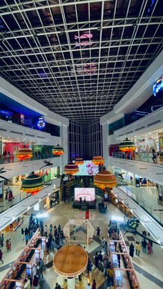 the inside of a shopping mall with people walking around