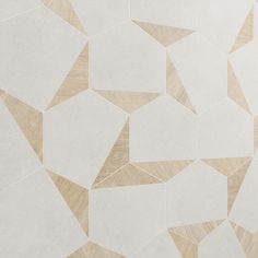 a white and beige tiled wall with different shapes