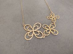 Unique long flower Necklace, threaded on a delicate gold-filled chain. Made of 24k gold plated brass base. Necklace length 31.4 inch 80 cm Item will be shipped in a branded gift box. Complete the look with the matching Golden Flower Earrings. To continue shopping, check out my Etsy store: https://www.etsy.com/shop/HilaAssaJewelry To see matching earrings click here: https://www.etsy.com/listing/269936465 For more necklaces click here: https://www.etsy.com/shop/HilaAssaJewelry?section_id=17714126 Gold Necklaces With Flower Decoration For Wedding, Delicate Gold Necklace With Flower Decoration, Gold Necklace With Flower Decoration For Wedding, Gold Flower Necklaces With Flower Decoration, Gold Flower Necklace With Floral Decoration, Delicate Gold Flower Necklace, Handmade Gold Flower Necklace, Delicate Gold Flower Charm Necklace, Yellow Gold Flower Necklaces For Wedding