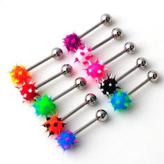 six different colored spikes and balls on a white surface