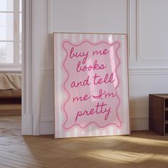 a pink sign that says, buy me books and tell me i'm pretty