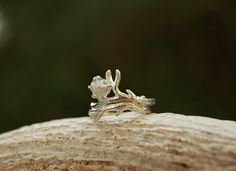 We are excited to introduce THE BUNDOLYN! We worked with an amazing artisan out of California to make this handmade beauty. This ring features a stunning raw, natural diamond surrounded by a beautiful and unique Sterling Silver bud branch. 2 rings included in this set. The band is hand-formed from a sheet of sterling silver and wire to create a stunning authentic design. ABOUT THIS RING Gemstones: Natural Raw Diamond Metal: Sterling Silver Color/Finish: Silver, Polished QUESTIONS ABOUT SIZING Go Antler Ring, Handmade Beauty Products, Authentic Design, Raw Diamond, 2 Set, Natural Tones, Polish Jewelry, Diamond Gemstone, Silver Color