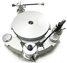 a silver turntable sitting on top of a white table