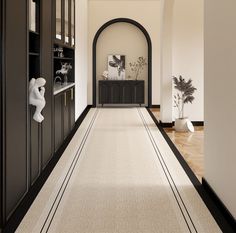 the hallway is clean and ready for guests to use it as an entrance way in this home