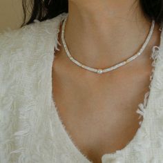 Indulge in the enchanting beauty of our White Mother of Fritillary Pearl Necklace—a masterpiece of craftsmanship featuring exquisite 18K gold-plating. Meticulously crafted from high-quality copper, adorned with freshwater pearls, and accentuated by the timeless allure of white mother-of-pearl, this necklace is a true embodiment of sophistication. Key Features: Lustrous 18K Gold Plating: Immerse yourself in the radiance of our necklace, boasting an opulent 18K gold-plated finish. The meticulous p Gemstone Beaded Necklace, Mother Of Pearl Necklace, Pearls Necklace, Feather Light, Mother Pearl, Swarovski Pearls, Recycled Gold, Keep Jewelry, Smokey Quartz