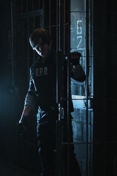 a man standing in front of a metal cage