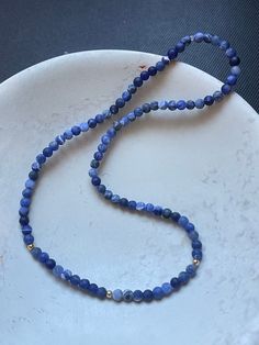 "This is a beautiful blue and gold beaded choker necklace.  The blue beads are 4mm and the 14 K gold beads are 2mm.  The necklace is 7\" in length." Elegant Blue Hand-strung Beaded Necklaces, Blue Single Strand Choker Jewelry, Blue Gemstone Beads Choker Necklace, Blue Lapis Lazuli Beaded Bracelets, Gold Single Strand Lapis Lazuli Beaded Necklace, Blue Single Strand Lapis Lazuli Beads, Blue Lapis Lazuli Gemstone Beaded Necklaces, Blue Lapis Lazuli Single Strand Beads, Single Strand Blue Lapis Lazuli Beads