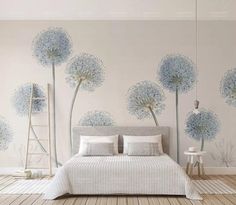 a bedroom with blue flowers painted on the wall