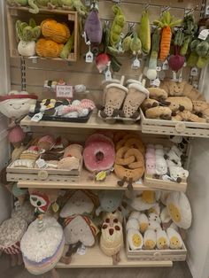 shelves filled with different kinds of donuts and other items on display in a store