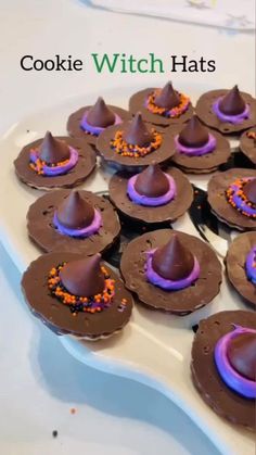 chocolate witch hats with sprinkles on a white plate