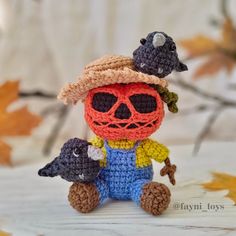 a crocheted doll with two little birds on his head