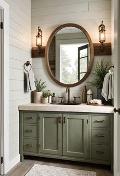 A rustic bathroom cabinet in Evergreen Fog with bronze hardware and wooden accents.