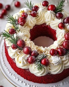 a red velvet cake with white frosting and cranberry toppings on top