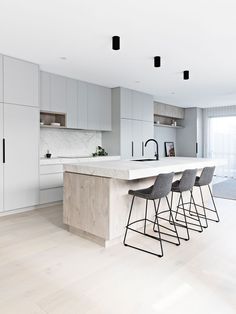 a kitchen with an island and bar stools