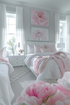 a white and pink bedroom with flowers on the bed in front of two large windows