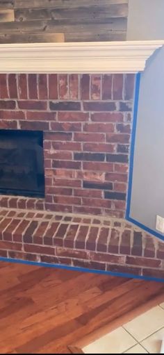 a brick fireplace with blue tape around it