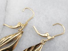 Sleek and polished, these stylized teardrop gold earrings are an absolute classic. Hung on simple lever back findings, these are versatile and lovely, easy to transition from casual to formal wear! Metal: 18K Yellow Gold Earrings Length: 41 mm Earrings Width: 10 mm Marks: "750" Stamped on the Findings Formal Gold Teardrop Earrings With Lever Back, Yellow Gold Teardrop Earrings With Lever Back, Yellow Gold Teardrop Earrings With French Hook, Formal Yellow Gold Hypoallergenic Teardrop Earrings, Formal Teardrop Earrings With Ear Wire, Formal Hypoallergenic Yellow Gold Teardrop Earrings, Formal Pear-shaped Teardrop Earrings With Lever Back, Classic Teardrop Earrings With French Hook For Formal Occasions, Formal Dangle Teardrop Earrings With French Hook