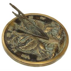 a brass plate with two birds on it