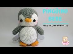 a crocheted penguin sitting on top of a white table