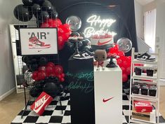 a room filled with balloons and decorations for a nike birthday party that is ready to blow out the candles