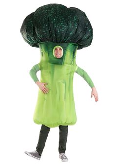 a person in a green dress with a large mushroom on his head and hands out to the side