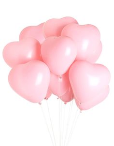 a bunch of pink heart shaped balloons floating in the air