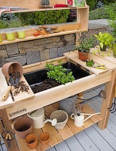 an outdoor garden with potted plants and gardening tools