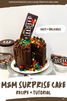 Candy filled M&Ms surprise cake, center of cake filled with M&Ms candy. Chocolate cake and frosting with a chocolate ganache drip, topped with an M&Ms box. Slice cut out to show candy center spilling out of inside. M M Cake Ideas, Candy Filled Cake, M M Birthday Cake, Alien Cake, Campfire Cake, Chocolate Candy Cake, Chocolate Cream Cheese Frosting, Gravity Cake, Surprise Cake