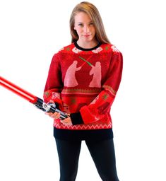 a woman in a red sweater is holding a lightsaben