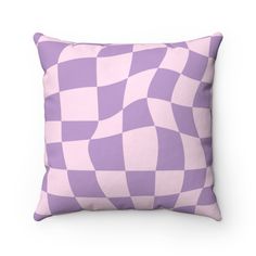 a purple and white checkered pillow on a white background