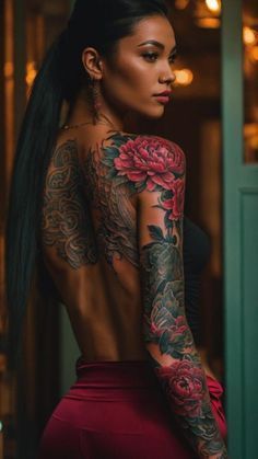 a woman with tattoos on her back and arms