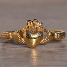 The 123rd Avenue: Yellow Gold Claddagh Ring With Adjustable Shank. This Claddagh Ring Could Be Used As A Mid Finger Ring, Or Toe Ring And Is Crafted In 14 Karat Yellow Gold. The Ring Is Currently A Finger Size 3.5 Yet Has An Open Back So It Can Be Adjusted To Fit Any Size! Mid Finger, Mid Finger Rings, Gold Claddagh Ring, Claddagh Ring, Claddagh Rings, Toe Ring, Finger Ring, Toe Rings, Gold Yellow