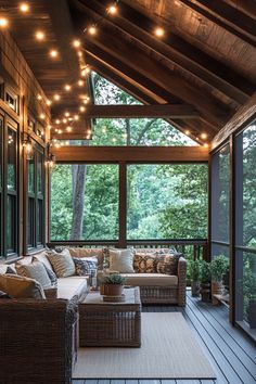 a covered porch with wicker furniture and string lights