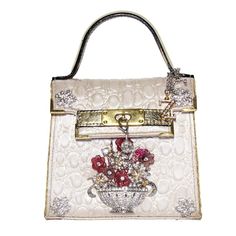 Platinum color embossed textile Wonderful metal crystals and swarovski applications Floral pattern Leather handle Button closure Can be carried crossbody too Cm 15 x 14 x 7 (5.9 x 5.5 x 2.7 inches) Luxury White Embellished Bag, Luxury Embellished White Bags, Luxury White Embellished Bags, Luxury Pouch Bag With Pearl Handle, Luxury Silver Shoulder Bag With Pearl Handle, Luxury Silver Bag With Pearl Handle, Luxury Beige Embellished Bags, Luxury Handheld Bags With Rhinestones, Luxury Shoulder Bag With Rhinestones