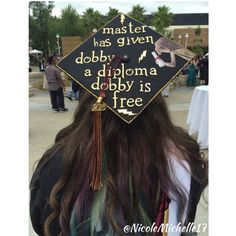 a person wearing a graduation cap with writing on it that reads master has given dobby a diploma is free