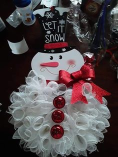 a snowman wreath with red and white decorations